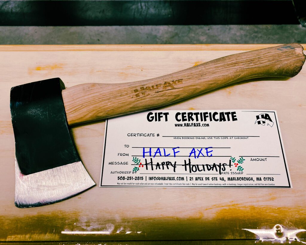 A picture of a hatchet with a wooden handle positioned above a gift certificate that says From: Half Axe - Happy Holidays!